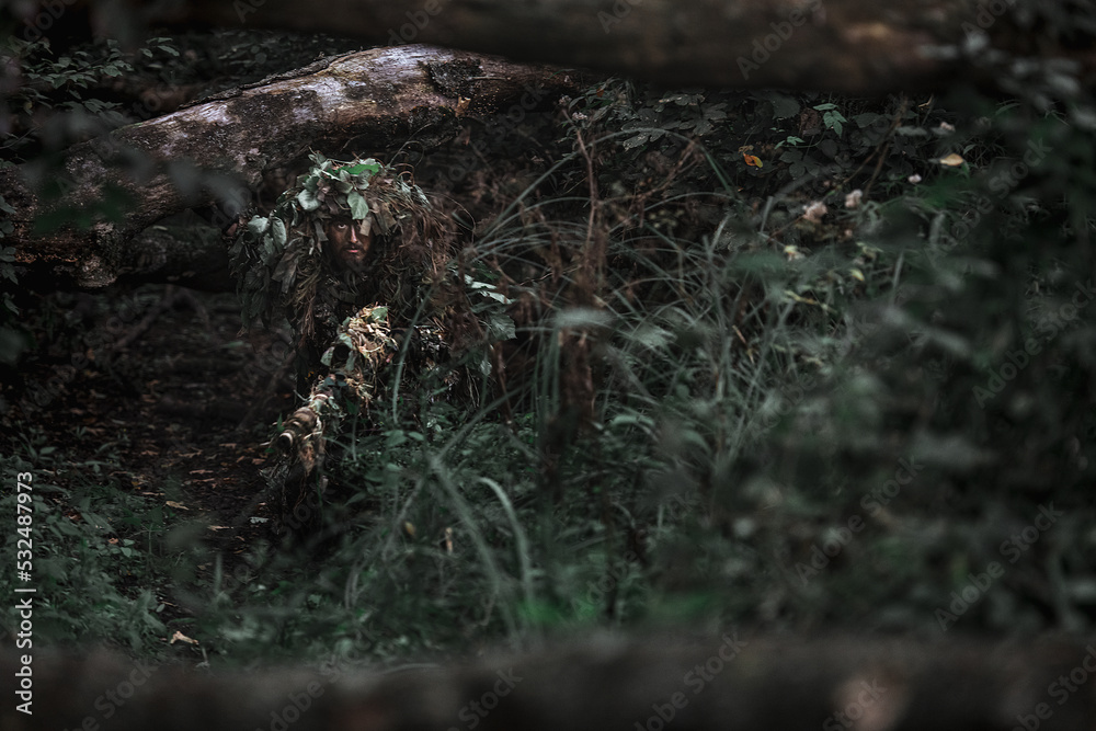 Eastern special forces soldier with rifle in woodland Eastern special forces soldier with rifle in woodland
