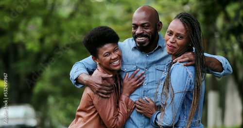 Three Friends hugging each other. African man and women embrace smiling