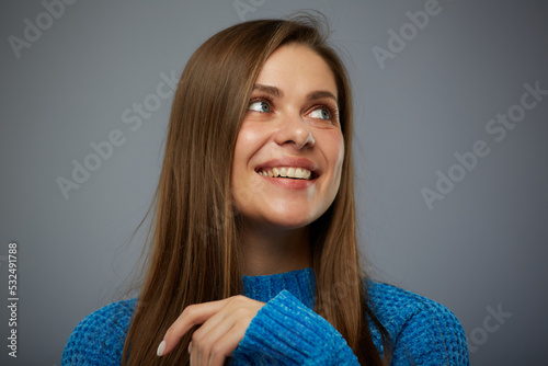 Close up face portrait of beautiful woman isolated on gray background looking away. photo