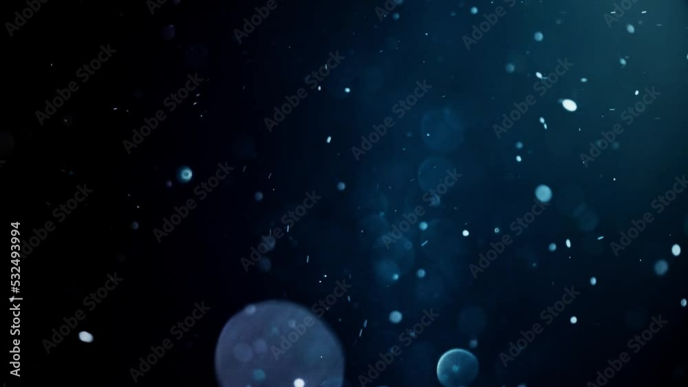 Gold dust particles fly in slow motion in the air lingering slowly. Dust Particles Background Bokeh Lights Background on Black Background 4k Footage Snow Particles Background.