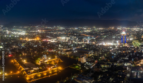 Ancient Japanese castle and city center lights in early evening © Osaze