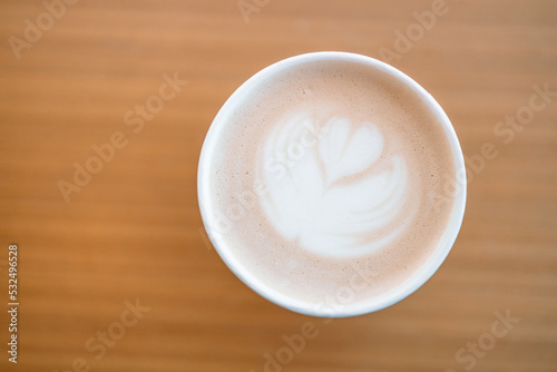 Coffee cup on wooden table background. Flat lay, top view . 