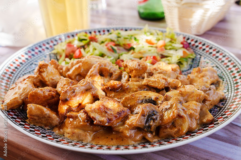 Traditional Middle Eastern dish. Main course with fried chicken and vegetables. Lebanese cuisine. Tender chicken meat in juicy sauce. Family dinner recipe. Traditional Middle Eastern dish. Main course with fried chicken and vegetables. Lebanese cuisine. Tender chicken meat in juicy sauce. Family dinner recipe.