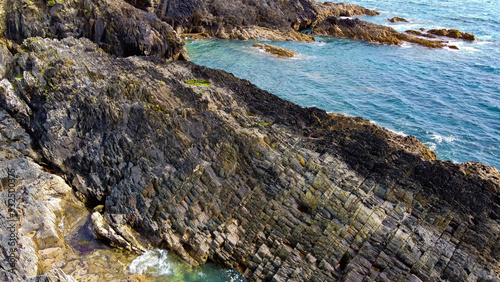 Calm sea surface and rocky shore. Coastal landscape, top view. Aerial photo.