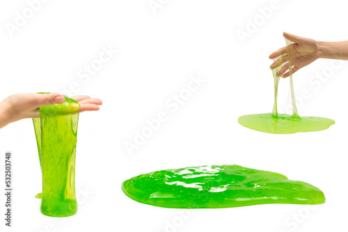 Green slime toy in woman hand isolated on white. photo