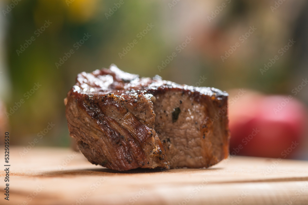 Closeup of grilled meat chunks served on wooden board Closeup of grilled meat chunks served on wooden board
