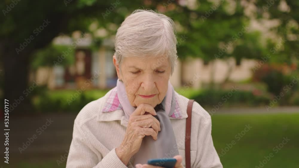 Senior woman with phone thinking and reading internet retirement news or online shopping on e commerce store or shop. Elderly person play smart and idea game on cellphone or mobile smartphone at park Senior woman with phone thinking and reading internet retirement news or online shopping on e commerce store or shop. Elderly person play smart and idea game on cellphone or mobile smartphone at park