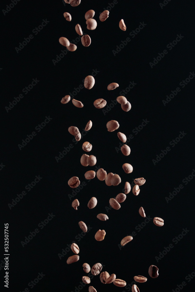 Coffee beans in flight on a dark background Coffee beans in flight on a dark background