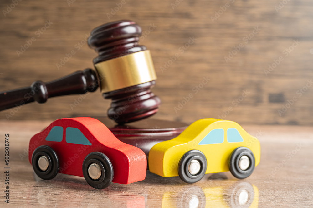 Hammer gavel judge with car vehicle accident, insurance coverage claim lawsuit court case.