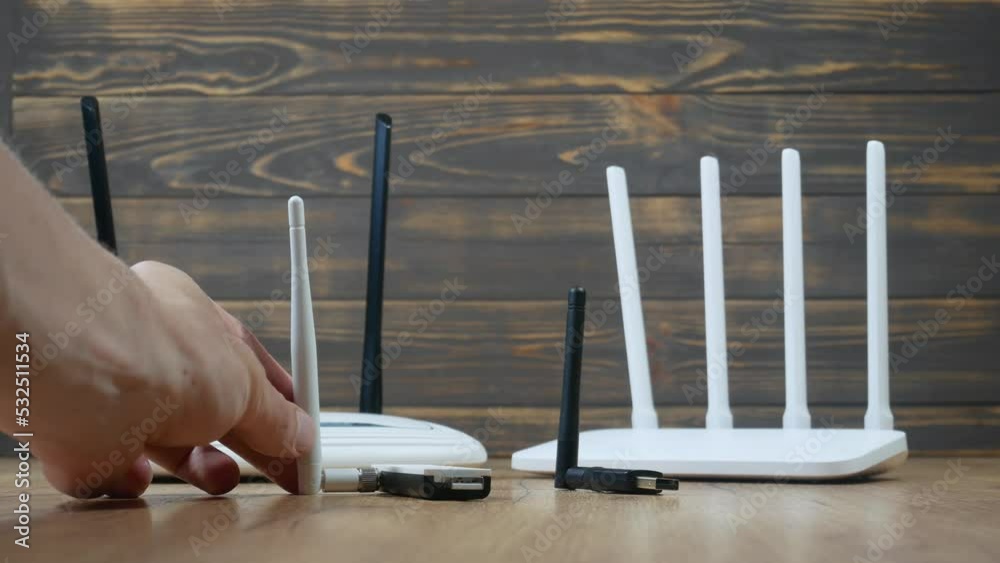 Man choose of different types of WiFi routers, modern and old