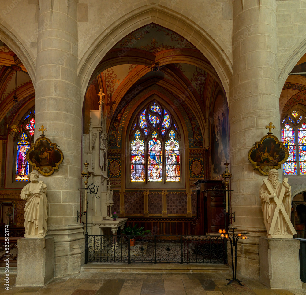 view of the altar and stained glass windows of a side chapel inside the Collegiale Notre Dame church in Dole view of the altar and stained glass windows of a side chapel inside the Collegiale Notre Dame church in Dole