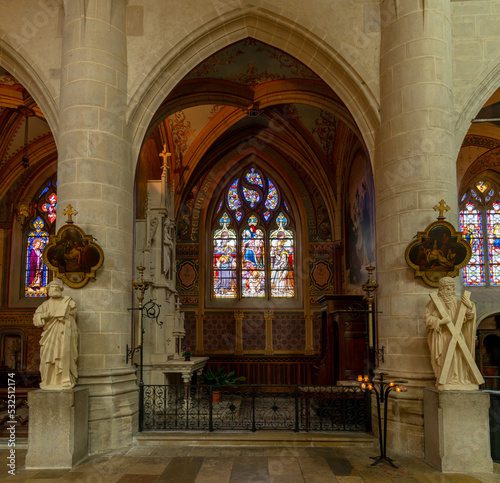 view of the altar and stained glass windows of a side chapel inside the Collegiale Notre Dame church in Dole