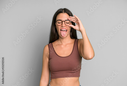 фотографія hispanic pretty woman smiling happily with funny face, joking and looking throug