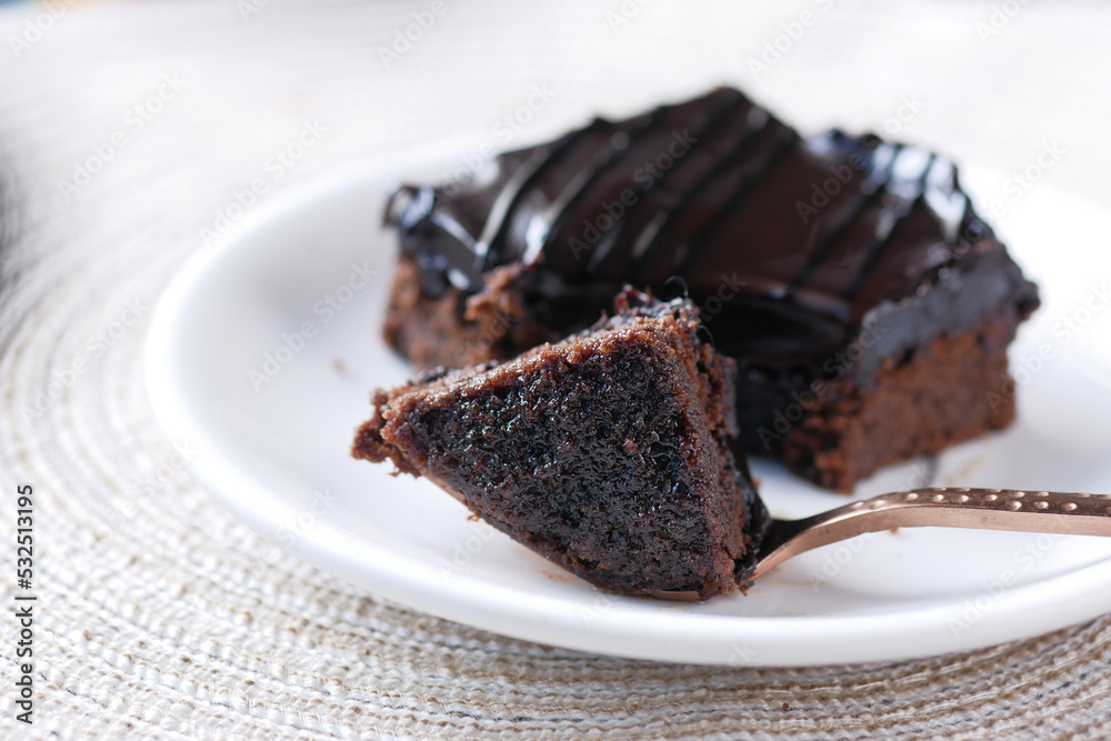 slow motion of pouring maple syrup on brownie on plate slow motion of pouring maple syrup on brownie on plate