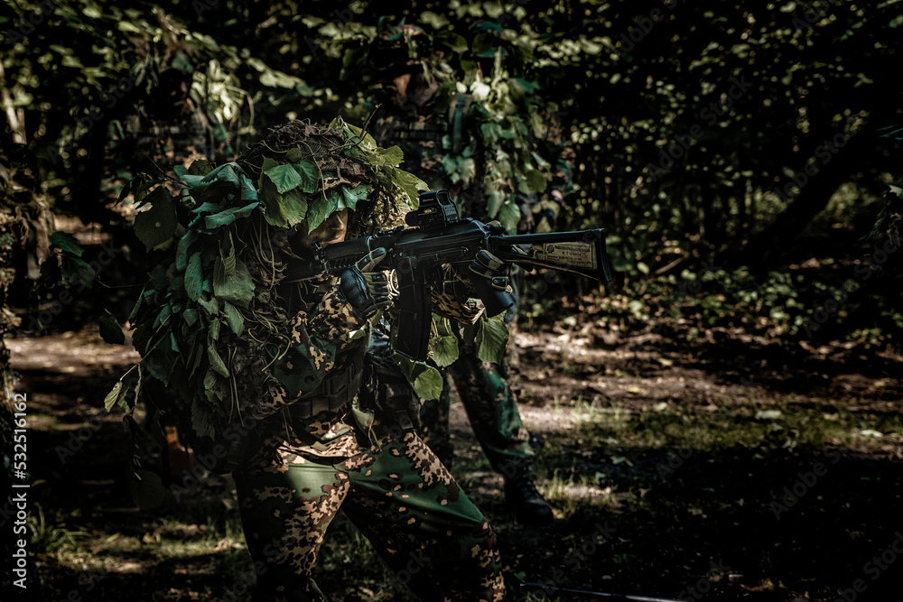 Eastern special forces soldier with rifle in woodland