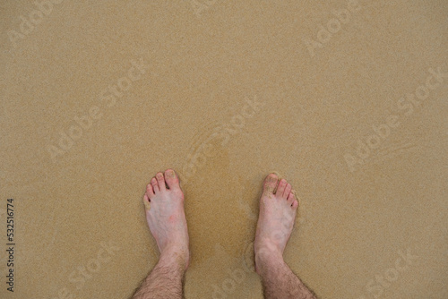 male feet on the beach, POV