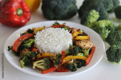 Stir fried vegetables with chicken. Air fried chicken tossed with sauteed bell peppers and broccoli. Served with boiled basmati rice