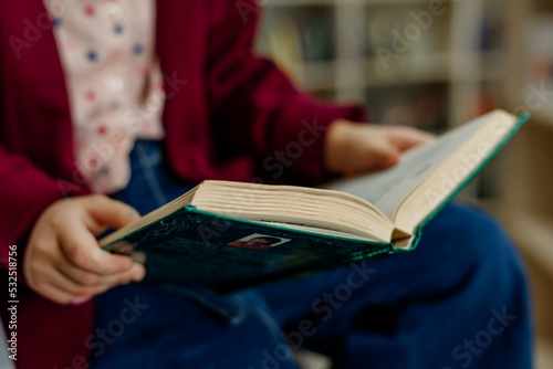 Close-up of a open book in the hands of a child
