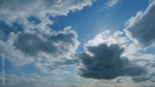 Changing stratocumulus cloudscape. Clouds inblue sky slowly move and change shape. Timelapse. photo