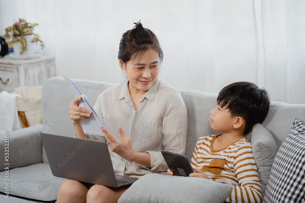 Handsome asian boy and his mother is working on a laptop computer. Frustrated and worried, the little boy pulled the paper from his mother's hand. want her to play with herself Handsome asian boy and his mother is working on a laptop computer. Frustrated and worried, the little boy pulled the paper from his mother's hand. want her to play with herself