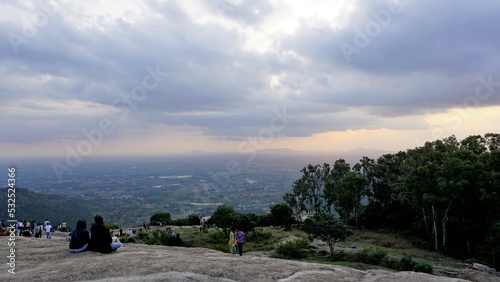 Nandi hills, Karnataka,India-May 22 2022: Tourists enjoying the beautiful scenic sunset from top of Nandi betta or Nandidurg.