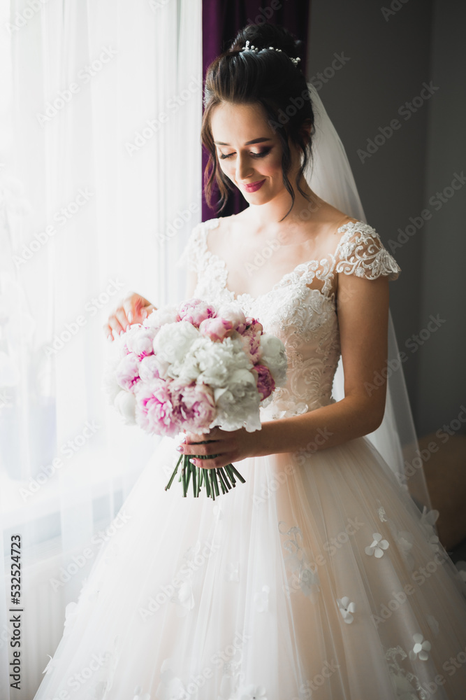 Bride holding big and beautiful wedding bouquet with flowers Bride holding big and beautiful wedding bouquet with flowers