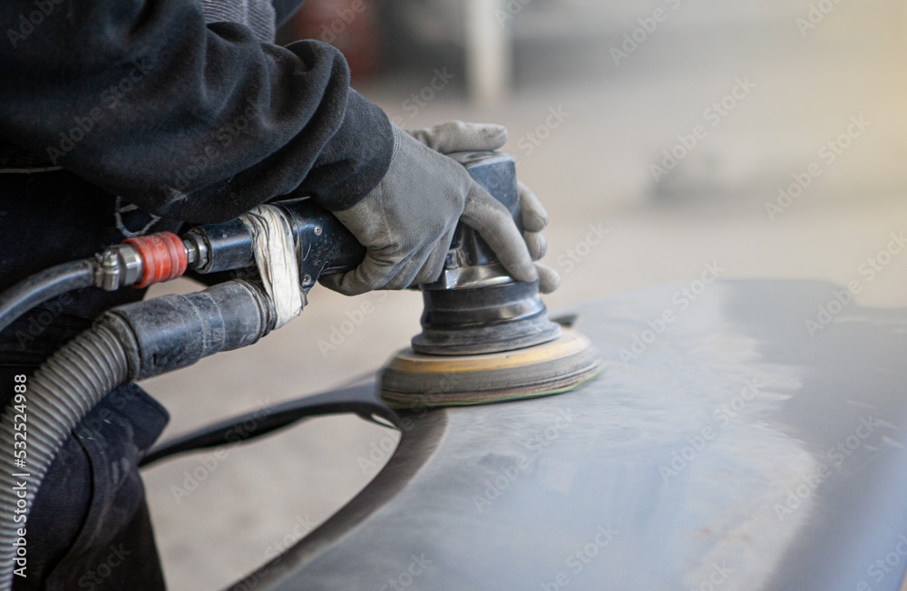 mechanic repairs car accident damage. The sheet metal mechanic working