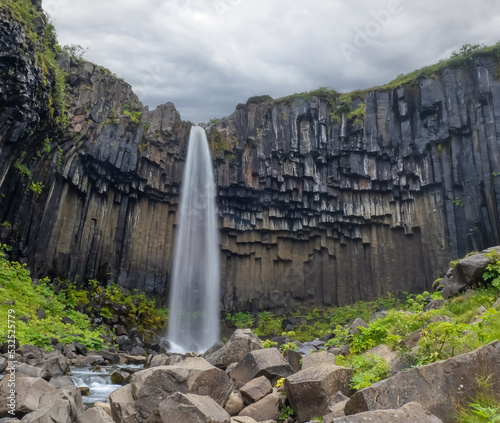 Svartifoss (black) waterfall in the Vatnajökull National Park, Southern Iceland. It is surrounded by dark basalt lava columns,