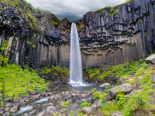 Svartifoss (black) waterfall in the Vatnajökull National Park, Southern Iceland. It is surrounded by dark basalt lava columns,