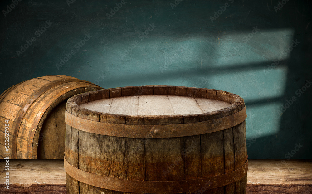 Fototapeta premium Beer. Still life with Vintage beer barrel and glass light beer. Fresh amber beer concept. Green hop and gold barley on wooden table. Ingredients for brewery. Brewing traditions. High quality photo