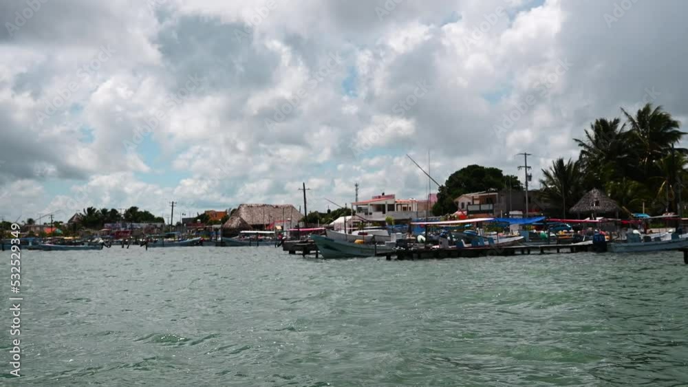 Coastal Mexican fishing village with boats waiting to take tourists out to Rio Lagarto to view wildlife refuge with flamingo, crocodiles and other animals. Coastal Mexican fishing village with boats waiting to take tourists out to Rio Lagarto to view wildlife refuge with flamingo, crocodiles and other animals.