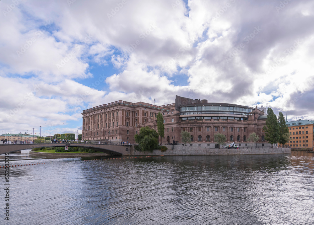 Fototapeta premium The Swedish Parliament on the island Helgeandsholmen in the stream Norrström with troubled water a cloudy autumn day in Stockholm 