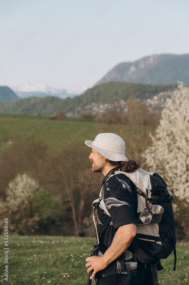 Cheerful hiker against hills and mountains Cheerful hiker against hills and mountains
