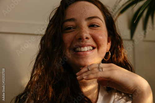 Optimistic freckled teen at home