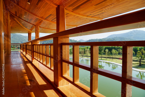 Horizontal photo of beautiful wooden building corridors japan style and natural scenery in the background.