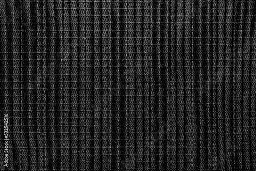 Textile. The material is gray or black in a small check. Fabric background with small squares. Texture