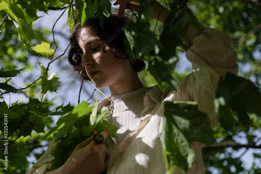 girl posing in the branches of a tree
girl posing in the branches of a tree
