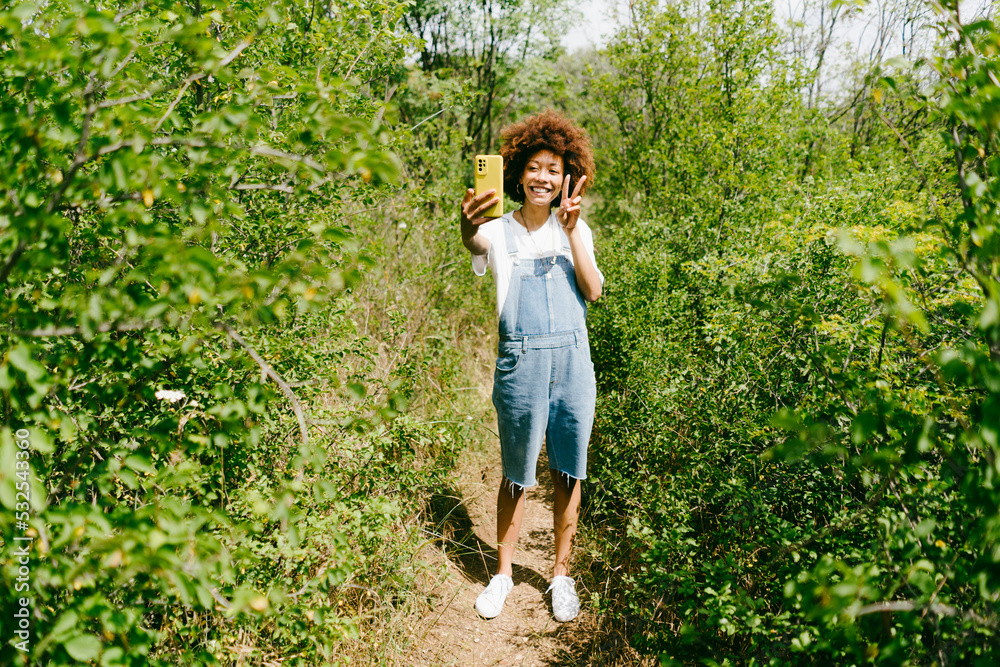 Woman takes a selfie outdoors Woman takes a selfie outdoors