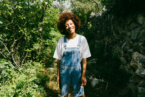 A smiling woman in the forest photo