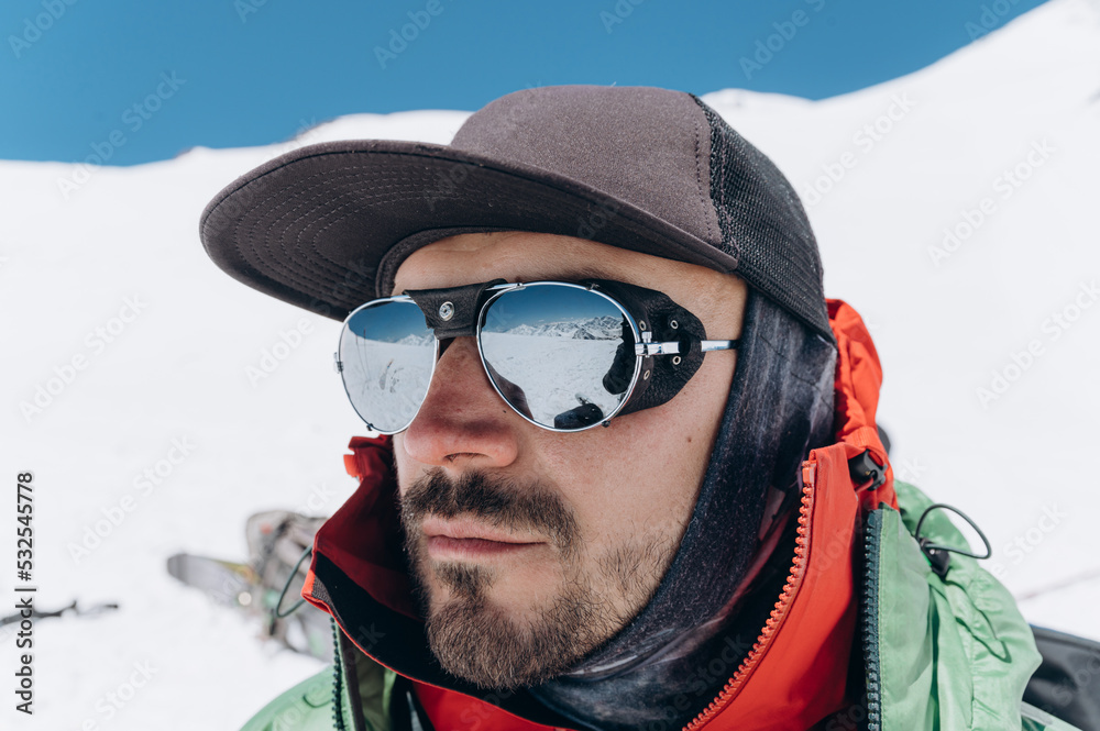 Young male hiker admiring nature in snowy mountains Young male hiker admiring nature in snowy mountains