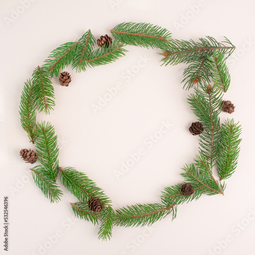 Christmas holiday background, frame with fir branches and cones, winter season greeting card with copy space

