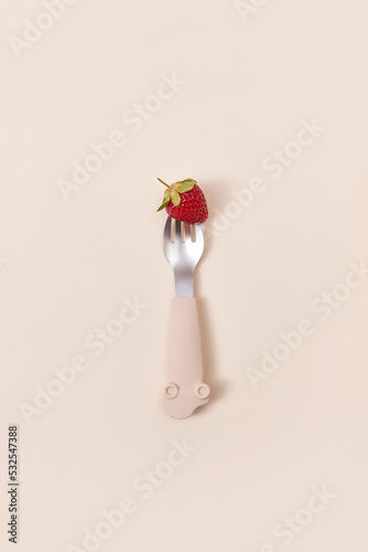 Little silicone fork with pricked strawberry.