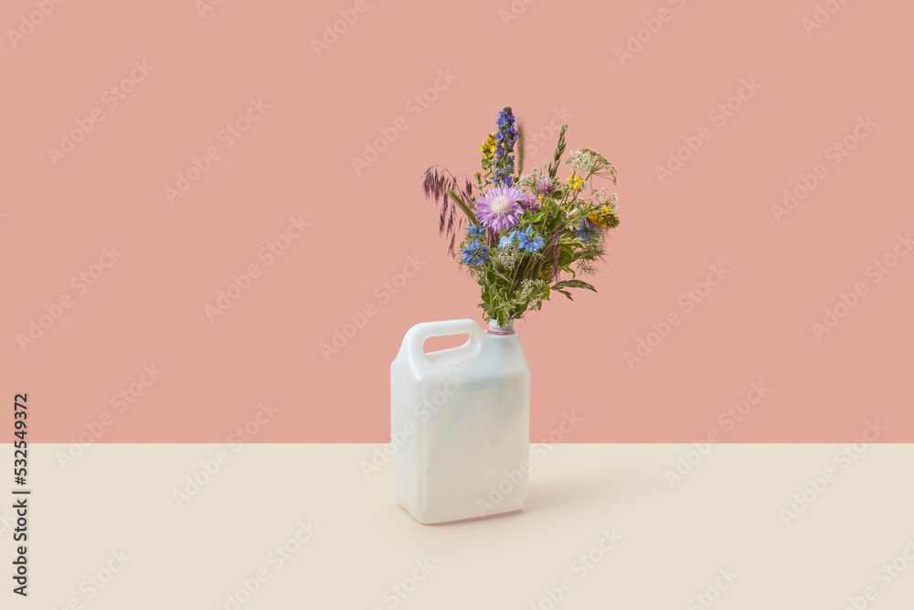 Plastic canister with bunch of fresh wildflowers. Plastic canister with bunch of fresh wildflowers.
