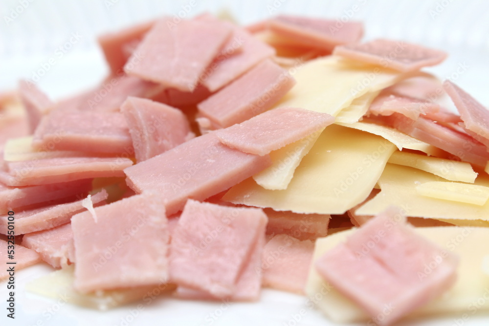 sliced cheese and ham to prepare the meal, pork and dairy separated as an ingredient to make the meal, food color pink and yellow sliced cheese and ham to prepare the meal, pork and dairy separated as an ingredient to make the meal, food color pink and yellow