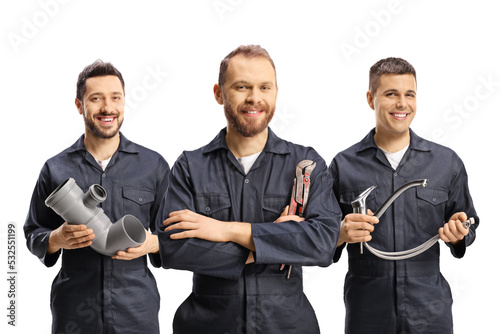 Team of plumbers holding plumbing equipment