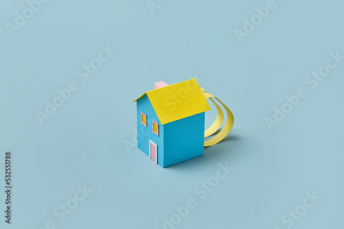 Blue and yellow paper backpack house. photo