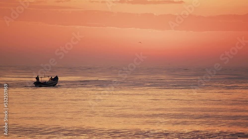 Fishing boat heading out to sea at sunrise, Itajaí - Santa Catarina
