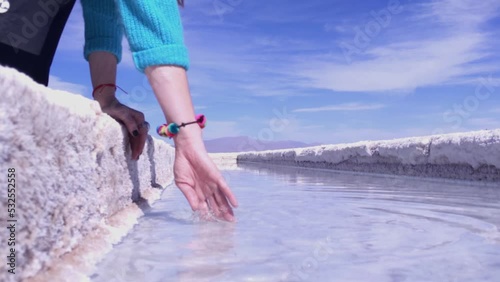 Woman Touching Salt Water at the  Salt Pools in Salinas Grandes Salt Flats, Jujuy province, Argentina. Close Up.   photo