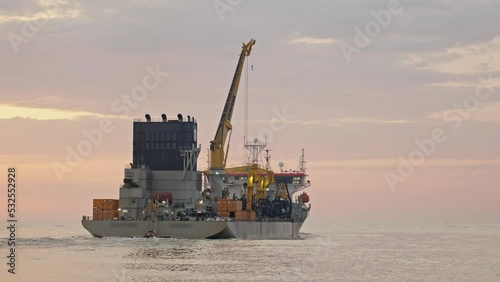 Dredge leaving river towards the sea at sunrise, Itajaí - Santa Catarina