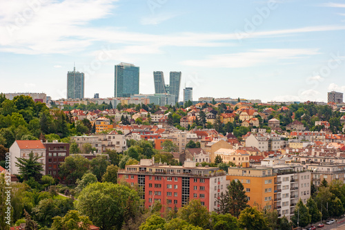 Modern day business skyline in Prague, Czech Republic. See red roofs and tall buildings. Photo taken from Vysehrad ramparts, edge of city center. Modern vs old.
